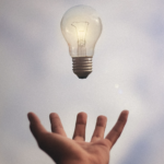 hand below light bulb